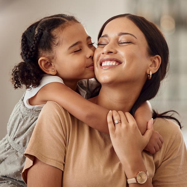 smiling mother with young daughter